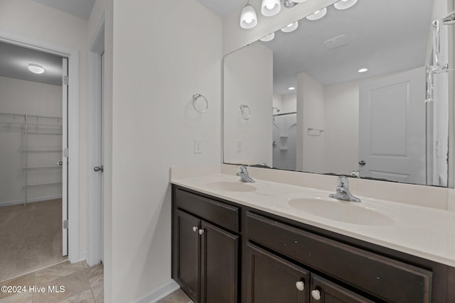 bathroom featuring a shower, vanity, and tile patterned floors