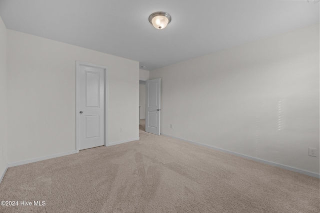 unfurnished bedroom with baseboards and carpet flooring