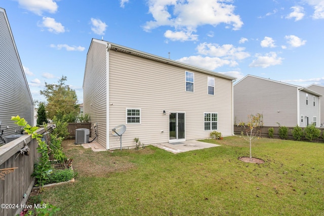 back of house featuring a patio, a yard, and central air condition unit