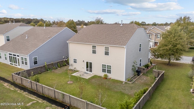 rear view of property with a lawn and a patio