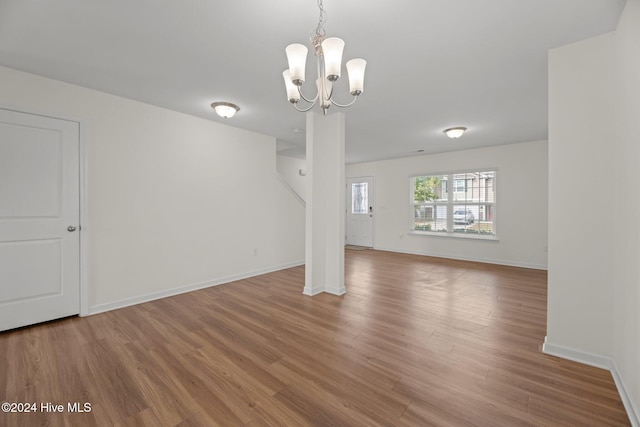 interior space featuring wood-type flooring and a notable chandelier