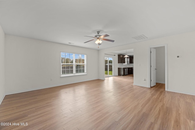 unfurnished living room featuring light wood-type flooring and ceiling fan