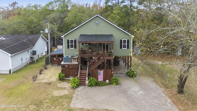 view of front facade featuring a wooden deck and central AC