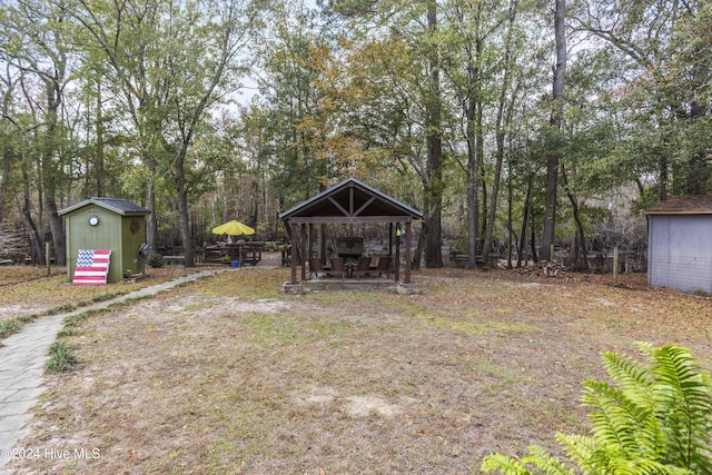 view of yard featuring a gazebo and a storage unit