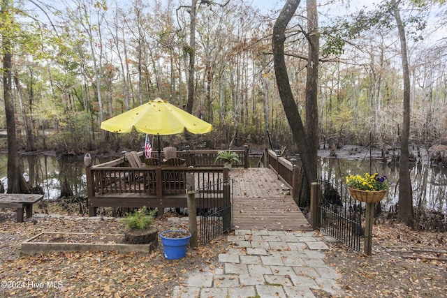 view of patio / terrace with a deck with water view