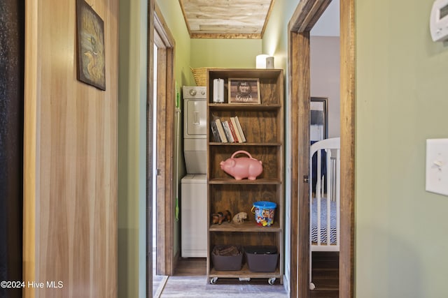 corridor with wooden ceiling, stacked washer and dryer, and dark wood-type flooring