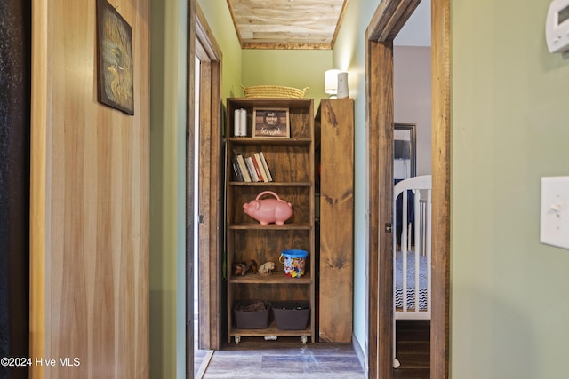 hallway with dark hardwood / wood-style flooring and wood ceiling