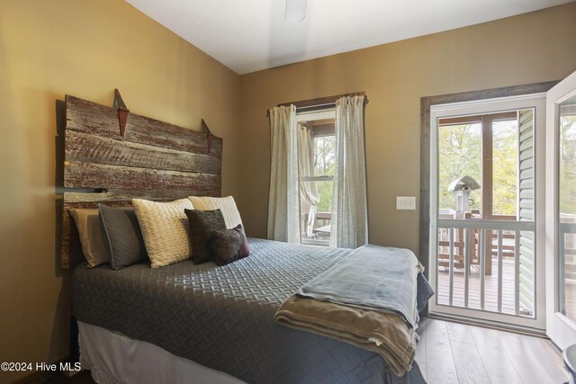 bedroom featuring access to outside and light hardwood / wood-style flooring