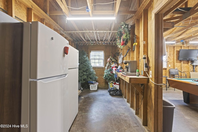 kitchen with white fridge, concrete flooring, and pool table