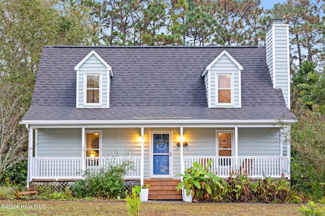 cape cod-style house with covered porch