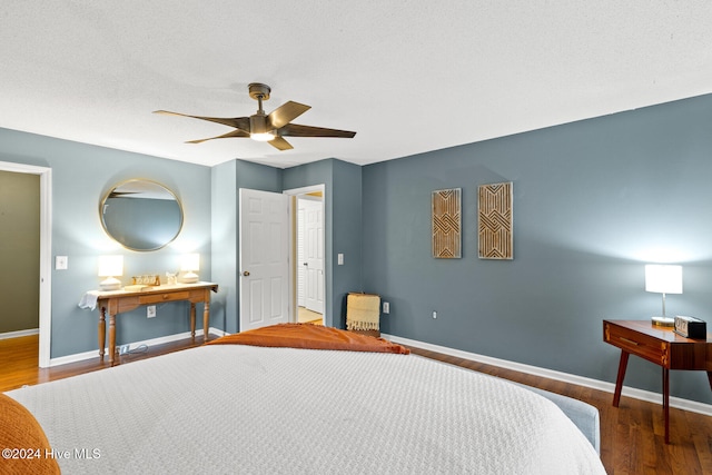 bedroom with ceiling fan and dark hardwood / wood-style floors