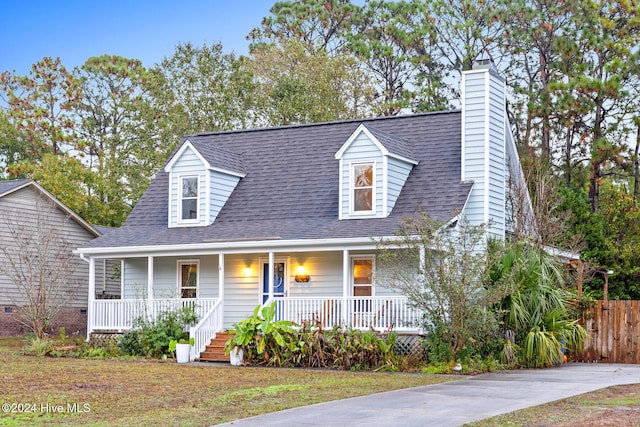 cape cod house featuring covered porch