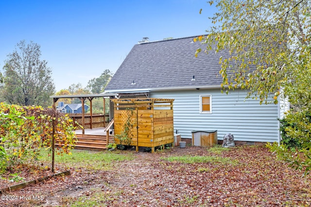 back of house featuring a wooden deck