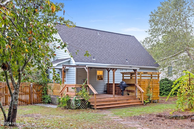 rear view of house with a wooden deck