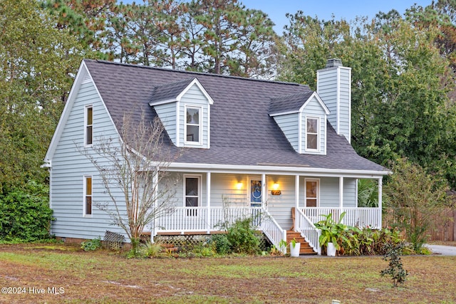 new england style home with covered porch