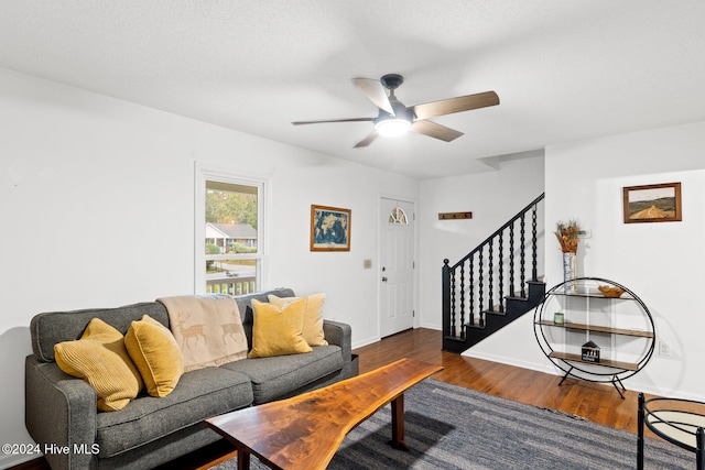 living room featuring ceiling fan and dark hardwood / wood-style floors