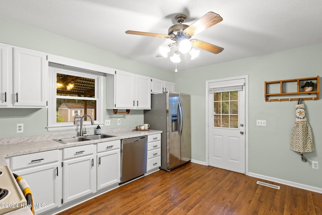 kitchen featuring white cabinets, dark hardwood / wood-style flooring, and appliances with stainless steel finishes