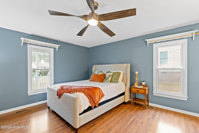 bedroom with hardwood / wood-style flooring and ceiling fan