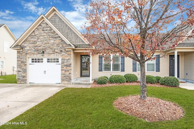 view of front of home featuring a front yard and a garage