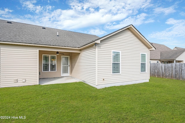 back of house with a patio area, a lawn, and ceiling fan