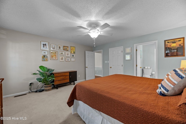 212 Outrigger Rd, New Bern, NC 28562 - carpeted bedroom featuring baseboards, a textured ceiling, a ceiling fan, and ensuite bath