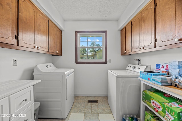 212 Outrigger Rd, New Bern, NC 28562 - laundry room with washing machine and clothes dryer, cabinet space, a textured ceiling, and baseboards
