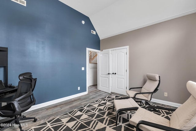 office space with high vaulted ceiling and wood-type flooring