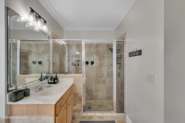 bathroom with a shower with door, vanity, and ornamental molding