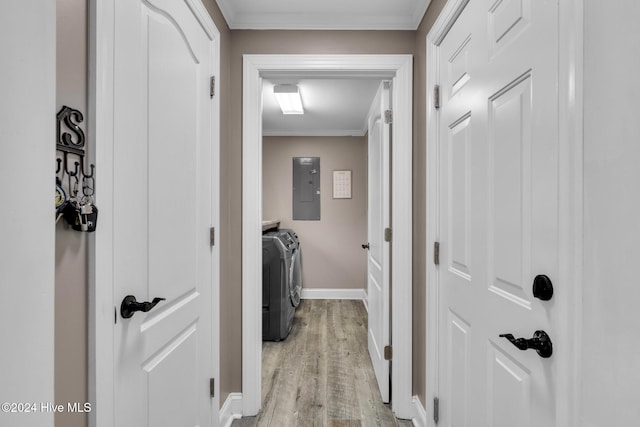 washroom featuring electric panel, separate washer and dryer, light hardwood / wood-style flooring, and crown molding