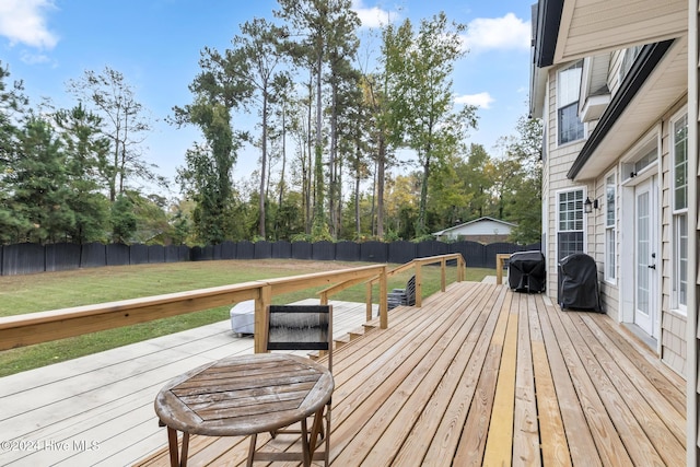 wooden deck featuring a yard