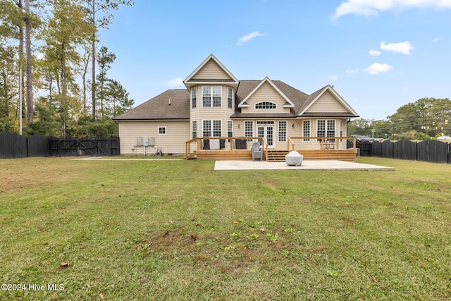 back of house with a patio and a lawn