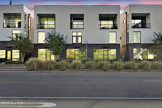 view of outdoor building at dusk