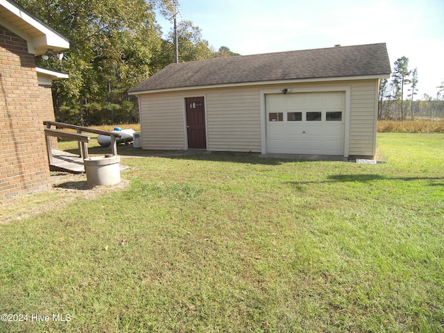 garage featuring a lawn