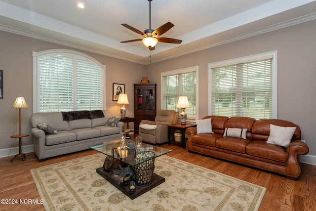 living room featuring hardwood / wood-style floors, ceiling fan, and ornamental molding