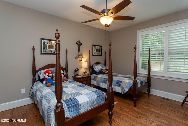 bedroom with ceiling fan and hardwood / wood-style floors