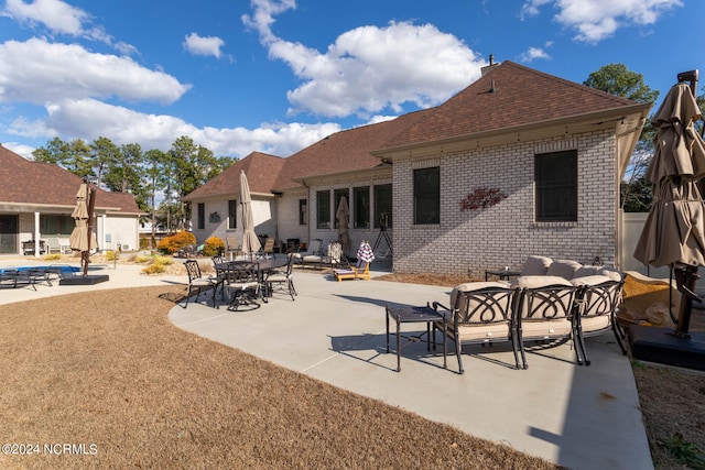 back of house featuring outdoor lounge area and a patio