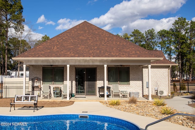 exterior space with a patio area and a fenced in pool