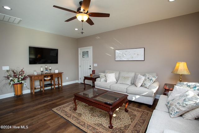 living room featuring dark hardwood / wood-style floors and ceiling fan