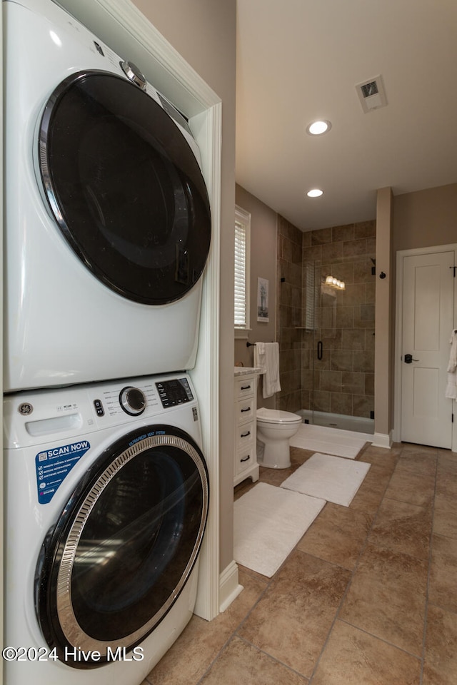 laundry room featuring stacked washer and clothes dryer