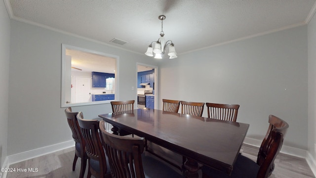 dining space featuring a chandelier, light wood-type flooring, and ornamental molding