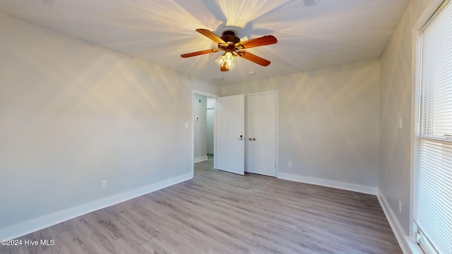 spare room featuring light wood-type flooring and ceiling fan