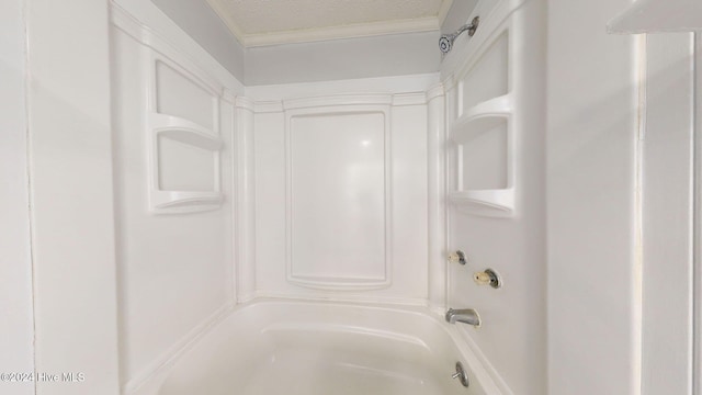 bathroom featuring ornamental molding, a textured ceiling, and washtub / shower combination