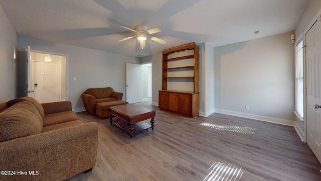 living room featuring wood-type flooring, a textured ceiling, plenty of natural light, and ceiling fan