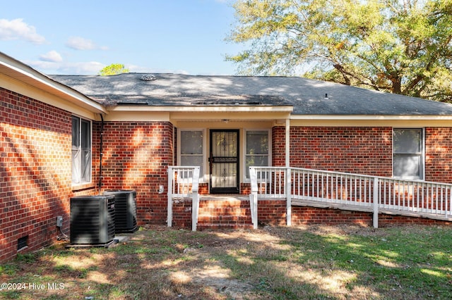 view of front of property with central AC, covered porch, and a front yard