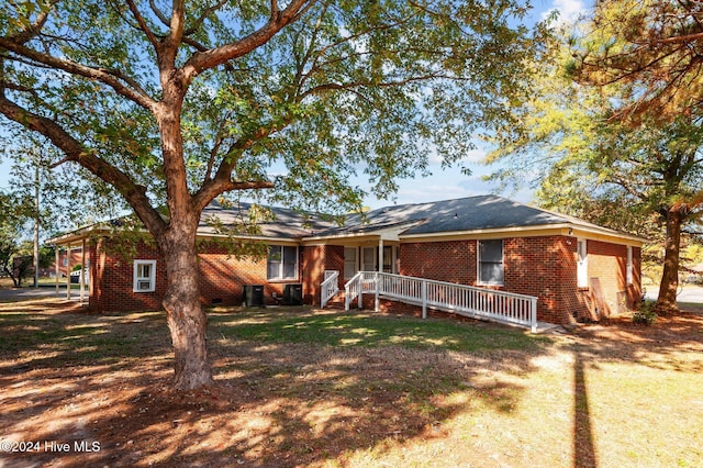 single story home featuring central AC unit