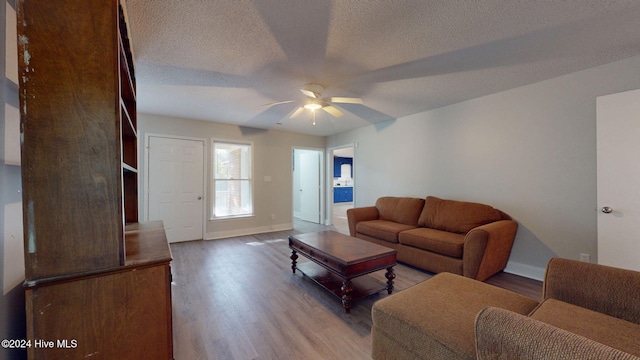 living room featuring a textured ceiling, hardwood / wood-style flooring, and ceiling fan