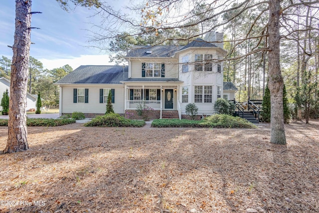 74 Driftwood Ct, Arapahoe, NC 28510 - view of front facade with covered porch, stairway, and a chimney