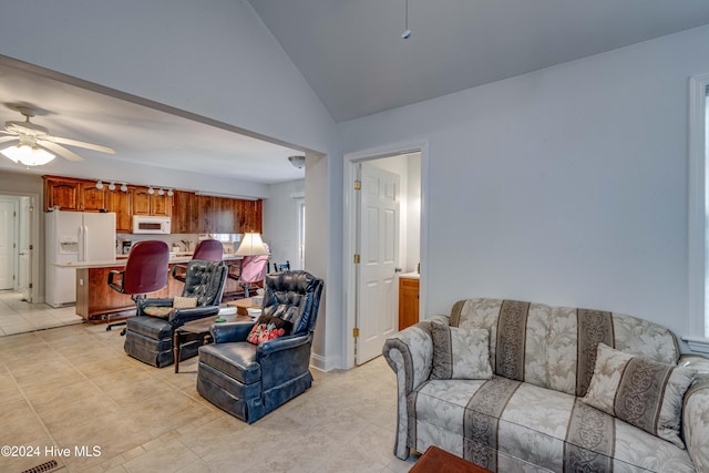 tiled living room with high vaulted ceiling and ceiling fan