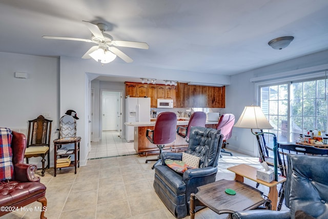 living room featuring light tile patterned flooring and ceiling fan