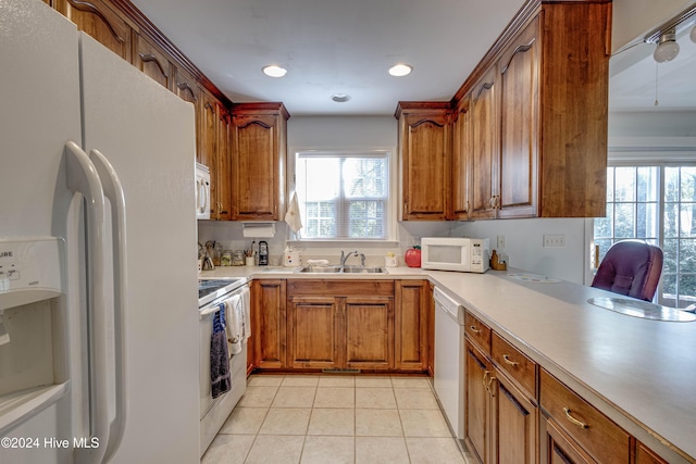 74 Driftwood Ct, Arapahoe, NC 28510 - kitchen with white appliances, a sink, brown cabinets, light tile patterned floors, and light countertops